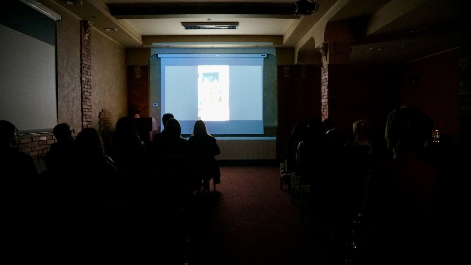A film being screened in a darkened hall
